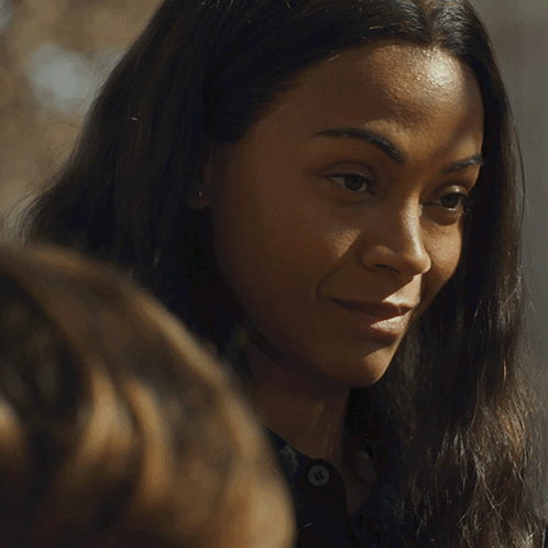 A Close Up Of A Woman 'S Face With A Smile On Her Face GIF