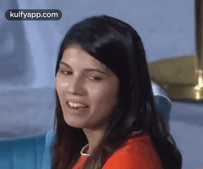A Close Up Of A Woman 'S Face With A Smile On Her Face . GIF