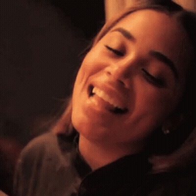 A Close Up Of A Woman 'S Face With A Smile On Her Face GIF