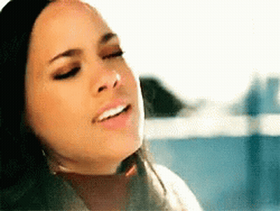 A Close Up Of A Woman 'S Face With A Smile On Her Face GIF