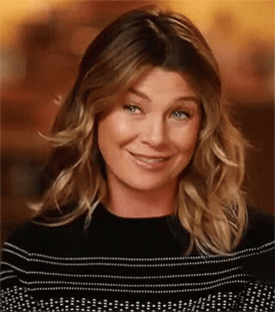A Close Up Of A Woman 'S Face With A Smile On Her Face . GIF
