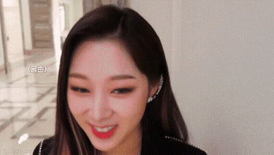 A Close Up Of A Woman 'S Face With A Smile On Her Face GIF
