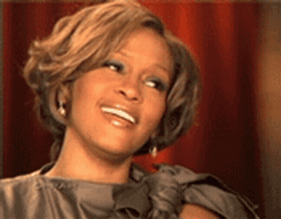 A Close Up Of A Woman 'S Face With A Smile On Her Face . GIF