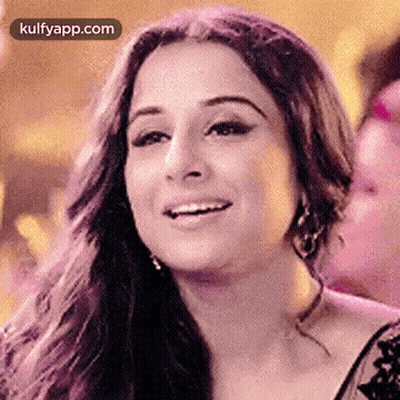 A Close Up Of A Woman 'S Face With A Smile On It . GIF