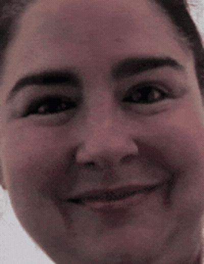 A Close Up Of A Woman 'S Face With A Smile On It GIF