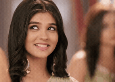 A Close Up Of A Woman 'S Face With A Smile On It GIF