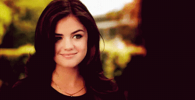 A Close Up Of A Woman 'S Face With A Smile On It . GIF
