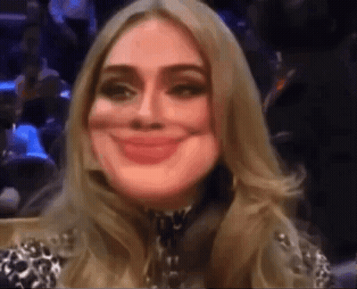 A Close Up Of A Woman 'S Face With A Smile On It GIF