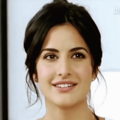 A Close Up Of A Woman 'S Face With A Smiling Expression . GIF