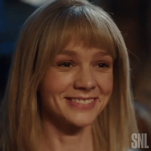 A Close Up Of A Woman 'S Face With A Snl Logo On The Bottom GIF