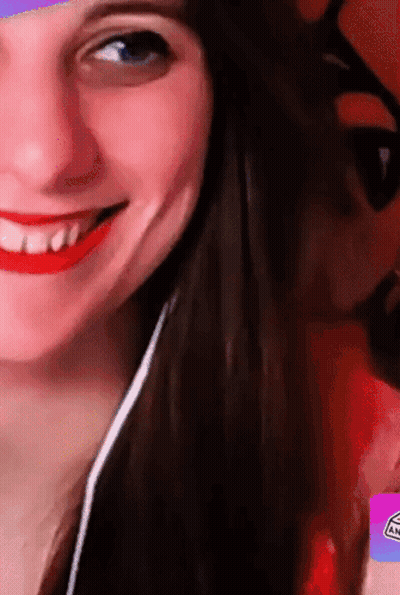 A Close Up Of A Woman 'S Face With A Sticker That Says An GIF