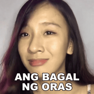 A Close Up Of A Woman 'S Face With A Sticker That Says Ang Bagai Ng Oras . GIF