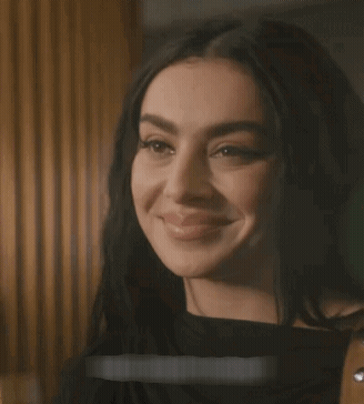 A Close Up Of A Woman 'S Face With A Sticker That Says ' I 'M Sorry ' On It GIF