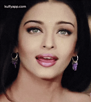 A Close Up Of A Woman 'S Face With A Surprised Look On Her Face . GIF