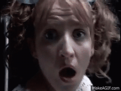 A Close Up Of A Woman 'S Face With A Surprised Look On Her Face .. GIF