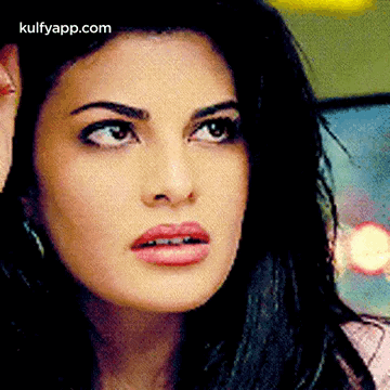 A Close Up Of A Woman 'S Face With A Surprised Look On Her Face GIF
