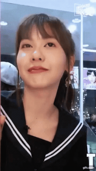 A Close Up Of A Woman 'S Face With A T On The Bottom Right GIF