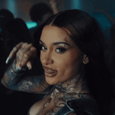 A Close Up Of A Woman 'S Face With A Tattoo On Her Face GIF