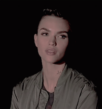 A Close Up Of A Woman 'S Face With A Tattoo On Her Neck GIF