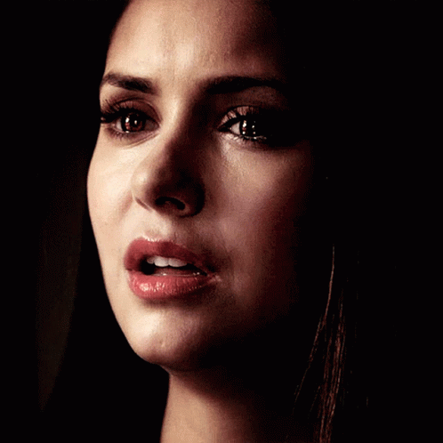 A Close Up Of A Woman 'S Face With A Tear Coming Out Of Her Eye GIF