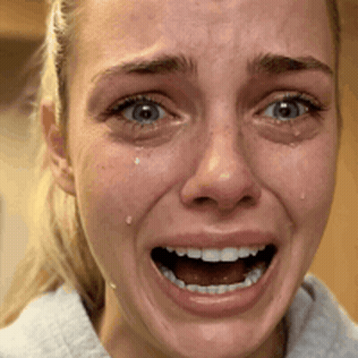 A Close Up Of A Woman 'S Face With A Tear Coming Out Of Her Eye GIF