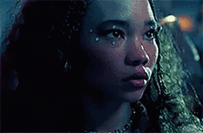 A Close Up Of A Woman 'S Face With A Tear Coming Out Of Her Eye . GIF