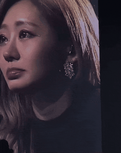A Close Up Of A Woman 'S Face With A Tear Coming Out Of Her Eye GIF