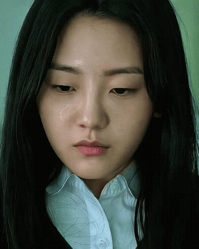 A Close Up Of A Woman 'S Face With A Tear Coming Out Of Her Eye GIF