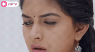 A Close Up Of A Woman 'S Face With A Tear Coming Out Of Her Nose . GIF