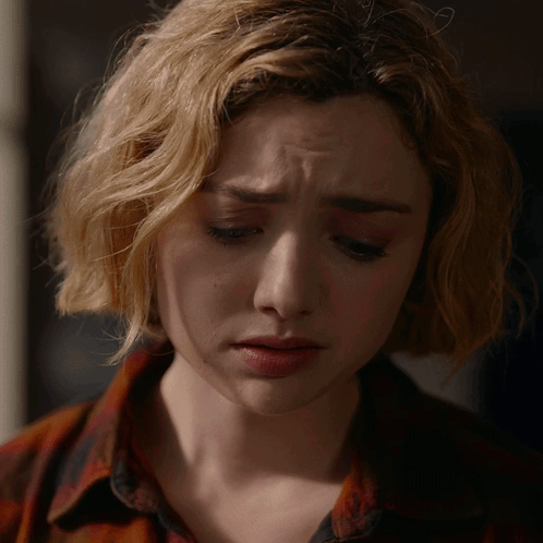 A Close Up Of A Woman 'S Face With A Tear On Her Cheek GIF