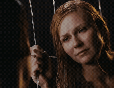 A Close Up Of A Woman 'S Face With A Tear Running Down Her Cheek GIF