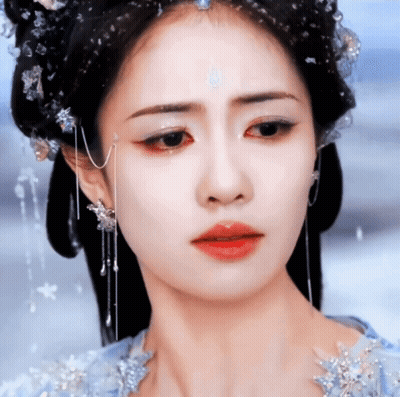 A Close Up Of A Woman 'S Face With A Tear Running Down Her Cheek GIF