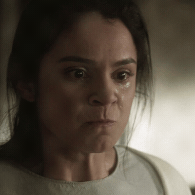 A Close Up Of A Woman 'S Face With A Tear Running Down Her Cheek GIF