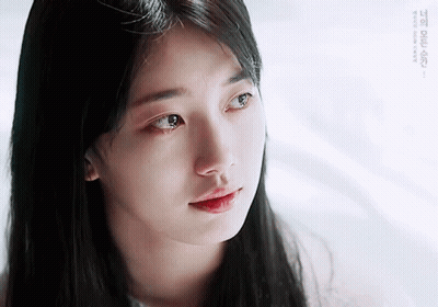 A Close Up Of A Woman 'S Face With A Tear Running Down Her Cheek GIF