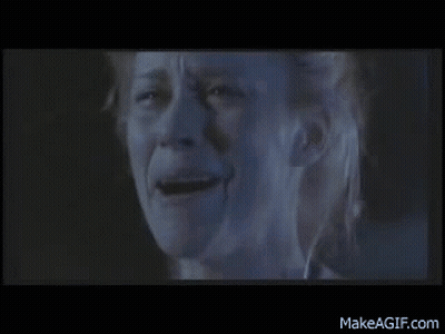 A Close Up Of A Woman 'S Face With A Tear Running Down Her Cheek . GIF