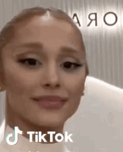 A Close Up Of A Woman 'S Face With A Tik Tok Sticker On It . GIF