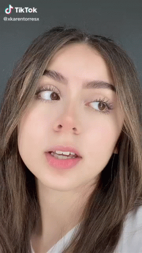 A Close Up Of A Woman 'S Face With A Tik Tok Watermark On It GIF
