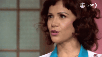 A Close Up Of A Woman 'S Face With A Tv Go Logo Behind Her GIF
