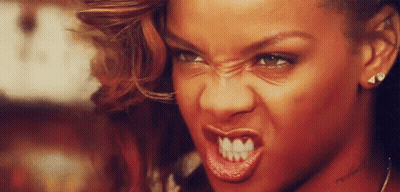 A Close Up Of A Woman 'S Face With A Very Angry Expression . GIF
