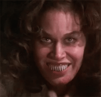 A Close Up Of A Woman 'S Face With A Very Large Smile . GIF