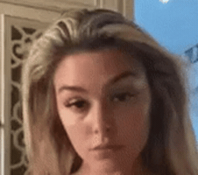 A Close Up Of A Woman 'S Face With A Very Serious Look On Her Face . GIF