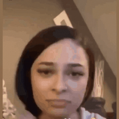 A Close Up Of A Woman 'S Face With A Very Serious Look On Her Face . GIF