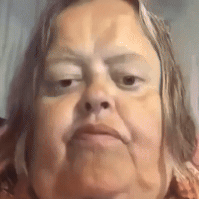 A Close Up Of A Woman 'S Face With A Very Serious Look On Her Face . GIF