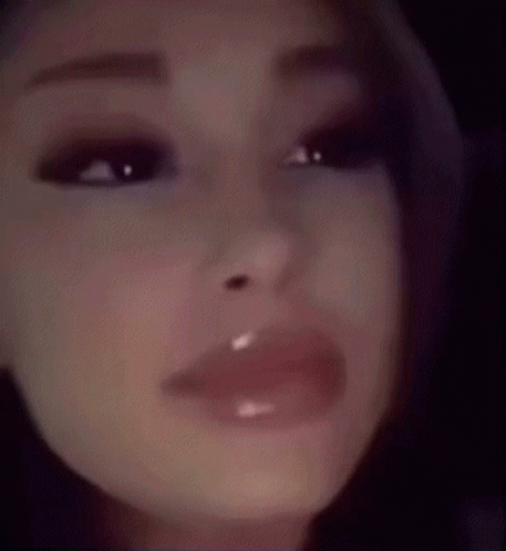 A Close Up Of A Woman 'S Face With A Very Shiny Lip Gloss On Her Lips . GIF