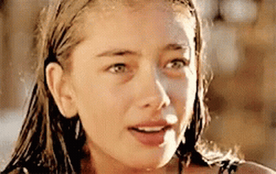 A Close Up Of A Woman 'S Face With A Wet Hair GIF