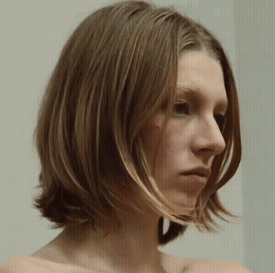 A Close Up Of A Woman 'S Face With A White Background GIF