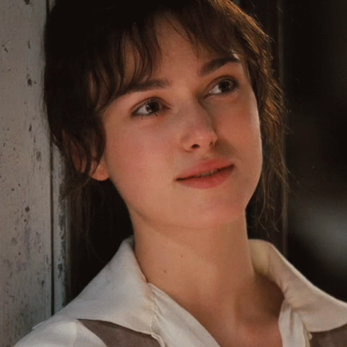 A Close Up Of A Woman 'S Face With A White Shirt GIF