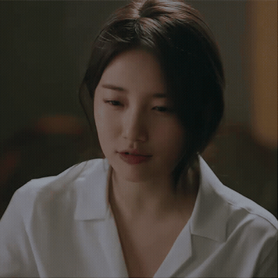 A Close Up Of A Woman 'S Face With A White Shirt GIF