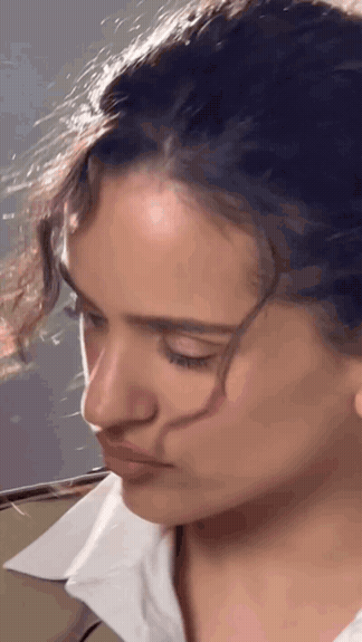 A Close Up Of A Woman 'S Face With A White Shirt GIF
