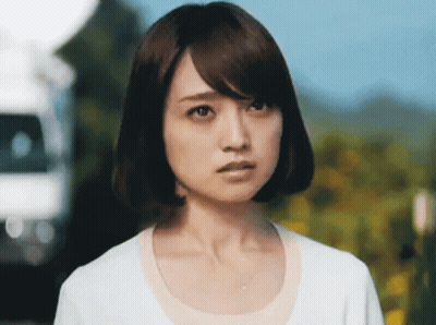A Close Up Of A Woman 'S Face With A White Shirt On GIF
